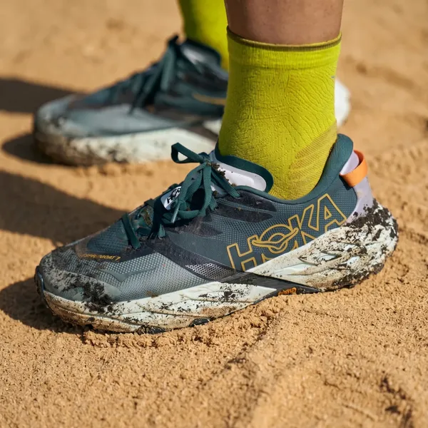 Trail running shoes on sand at a charity race